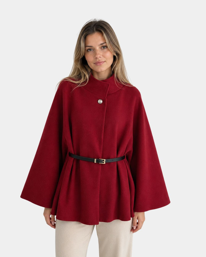 Elegantti poncho korkealla kauluksella ja vyöllä