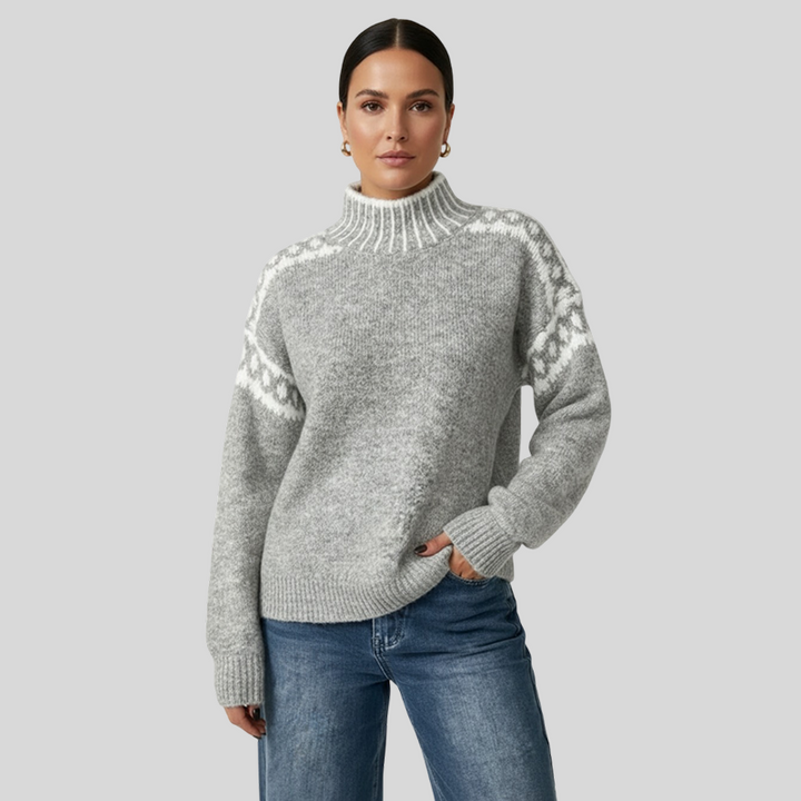Paksu neule, jossa on kontrastinen jacquard-kuvio olkapäissä